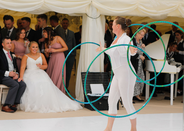 The 2 Lisas - Lisa T perfoming hulahooping for a wedding at Trerethern Farm