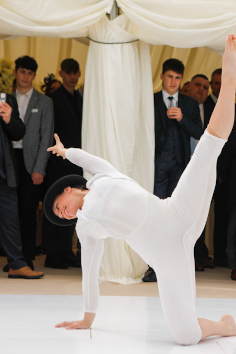Lisa Whitmore mid acrobatic pose at a marque wedding performance, Trerethern Farm.
