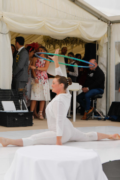 Lisa Truscott hula hooping in splits at a marque wedding performance, Trerethern Farm.