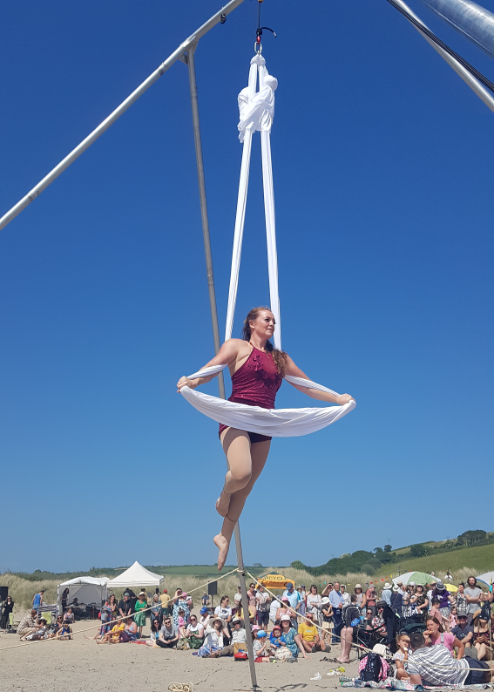 Lisa T performing aerial loop at Par beach on our free standing aerial rig | The 2 Lisas