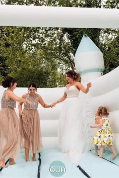 ride and bridesmaids enjoying a turret wedding bouncy castle by Enchanted Bouncey Castles