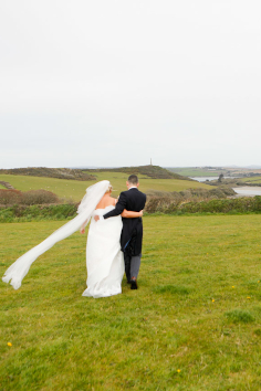 Bride and groom looking out from Trerethern Farm over Camel estuary